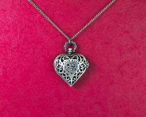 Heart clock necklace on Red background stock photo