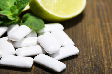 Chewing gums with fruit taste,   on color wooden background