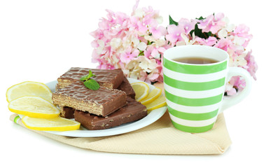 Cup of tea and sweets isolated on white