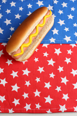 Tasty hot dog on napkin with stars, isolated on white