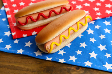 Tasty hot dogs on napkin with stars