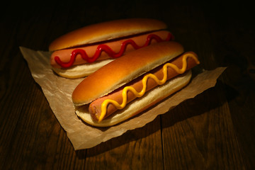 Tasty hot dogs on wooden table