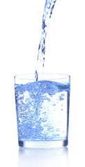 Pouring water into glass on blue background