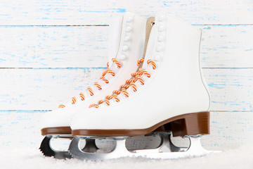 Figure skates on wooden background