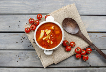 Bowl of tomato soup on wooden table