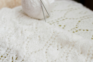 closeup detail of woven handicraft knit white sweater