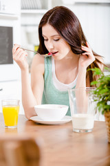 Portrait of the girl eating tasty cereals with milk  - 61230005