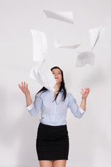 Woman throws out paper into the air