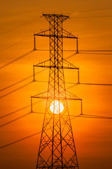 Silhouette of High voltage tower and the sun