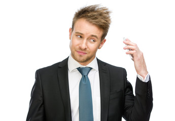 Half-length portrait of businessman keeping cell phone