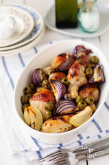 Fototapeta na wymiar Roasted Chicken Legs (Drumsticks) with Onions and Green Olives