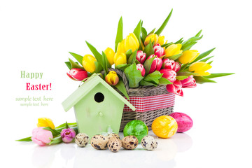 Easter eggs with tulips flowers and birdhouse, on a white backgr
