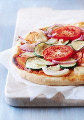 Vegetable pizza with zucchini, tomato and onion