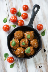 Meatballs with cherry tomatoes and corn salad, above view
