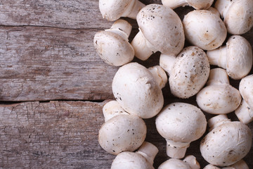 Fresh champignons on old wooden table. top view
