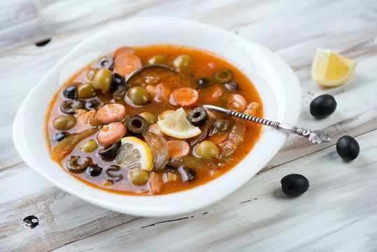 Solyanka: russian soup with meat, sausage and olives