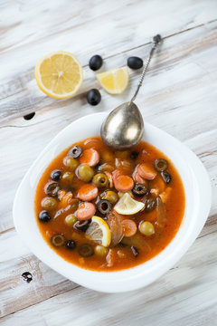 Russian traditional soup - solyanka, wooden background