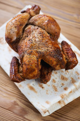 Vertical shot of a whole smoke-dried chicken, close-up