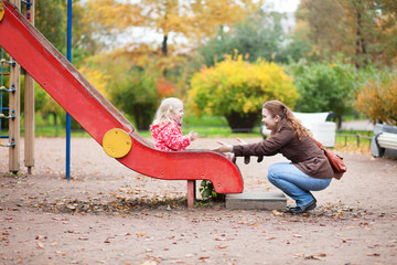 Mother and daughter on playground
