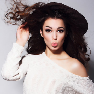 Expressive portrait of a beautiful brunette girl in the studio