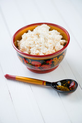 Cottage cheese in russian khokhloma tableware
