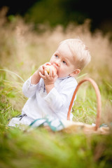 little boy with a basket and eats it with fruit