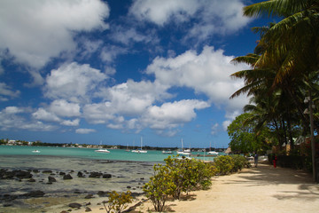 Tropical beach with boat and palms