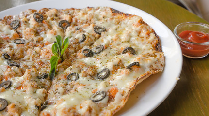 Pizza with Mozzarella, Salmon Slice, Black Olives and Vegetables