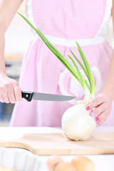 Obraz na płótnie Canvas Perfect housewife cutting onion