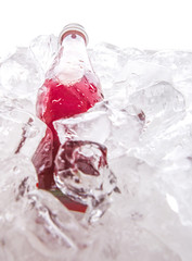 Bottled grape juice cooled with ice cubes