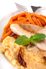 Chicken strips with baby carrots and mashed corn