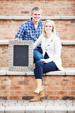 Caucasian Couple Sitting On Brick Steps