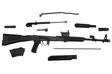 Assault rifle disassembled into parts isolated on white