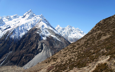 High mountains, snow-capped mountains in a blue sky