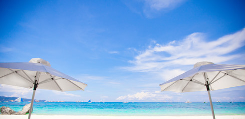 White umbrella at the beach background the blue sea