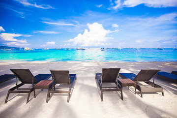 Beach chairs on exotic tropical white sandy beach