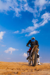 racer on a motorcycle in the desert