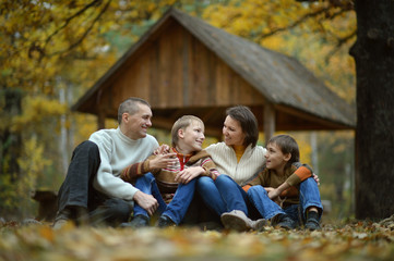 Fototapeta premium Happy family lying in autumn park