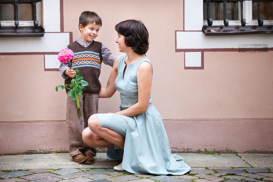 Little Boy Giving Flower To His Mom