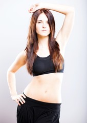Fototapeta na wymiar Young athletic woman posing in sports bra