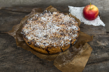 Apple pie and apple on old, rustic, wooden table