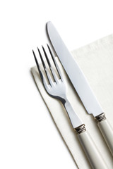 fork and knife on white napkin