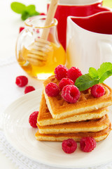 Waffles with raspberry, honey and chocolate.