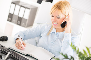 Beautiful Businesswoman telephoning in the office.