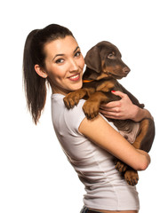 Brunette girl with her puppy isolated on white background