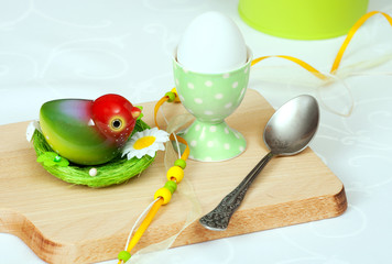 Easter egg with toy bird and toy nest