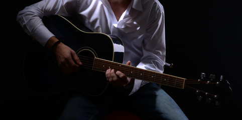 Young musician playing acoustic guitar and singing,