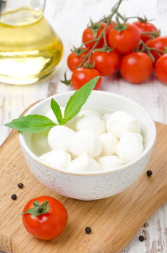 fresh mozzarella in a bowl and cherry tomatoes