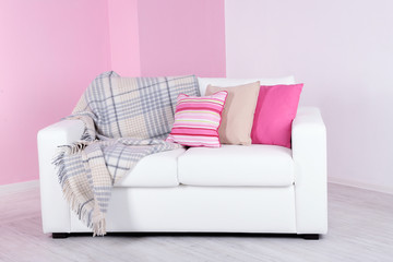 White sofa in room on pink wall background