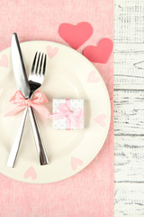 Romantic holiday table setting, on wooden background